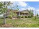 Ranch home with a covered porch and mature landscaping at 32501 E 137Th Way, Brighton, CO 80603