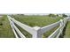 White wooden fence surrounds a large green field at 32501 E 137Th Way, Brighton, CO 80603