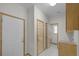 Hallway showcasing multiple doors and a glimpse into the bathroom area at 32501 E 137Th Way, Brighton, CO 80603