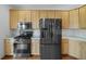 Kitchen featuring stainless steel appliances, granite countertops, gas range, and light wood cabinets at 32501 E 137Th Way, Brighton, CO 80603