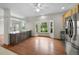 Bright eat-in kitchen featuring stainless appliances, granite countertops, a bay window, and hardwood floors at 32501 E 137Th Way, Brighton, CO 80603