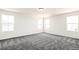 Spacious bedroom with gray carpet and natural light from multiple windows at 9264 Biscay St, Commerce City, CO 80022