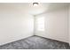 Bright bedroom with neutral walls, gray carpet, and window at 9264 Biscay St, Commerce City, CO 80022