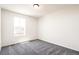 Bright bedroom featuring a window, plush gray carpet, and neutral paint at 9264 Biscay St, Commerce City, CO 80022
