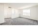 Bright bonus room features neutral decor, large window, and plush gray carpeting at 9264 Biscay St, Commerce City, CO 80022