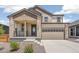 Beautiful two-story home featuring a stone and siding exterior with a two-car garage at 9264 Biscay St, Commerce City, CO 80022