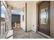 Inviting front porch featuring stone accents, a metal railing, and a dark-stained front door at 9264 Biscay St, Commerce City, CO 80022