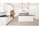 Stylish kitchen showcasing white cabinets, a central island with black countertops, and modern appliances at 9264 Biscay St, Commerce City, CO 80022