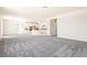 Open-concept living space featuring new paint, carpet, and a kitchen with a center island at 9264 Biscay St, Commerce City, CO 80022