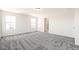 Large carpeted primary bedroom with an ensuite bathroom at 9264 Biscay St, Commerce City, CO 80022
