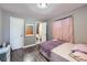 Bedroom featuring wood-look floors and ensuite bathroom at 2391 Kingston St, Aurora, CO 80010