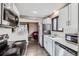 Updated kitchen showcasing stainless steel appliances and breakfast bar at 2391 Kingston St, Aurora, CO 80010