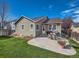 Large backyard with patio, grass, and a woodpile at 11462 Iola St, Commerce City, CO 80640