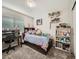 bedroom with built-in shelving and a desk at 11462 Iola St, Commerce City, CO 80640