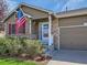 Front entry of charming ranch home with landscaped yard at 11462 Iola St, Commerce City, CO 80640