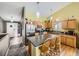 Open concept kitchen with island and stainless steel appliances at 11462 Iola St, Commerce City, CO 80640