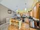 Kitchen boasts island, stainless steel appliances, and wood cabinets at 11462 Iola St, Commerce City, CO 80640