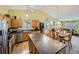 Eat-in kitchen with island, stainless steel appliances and wood cabinets at 11462 Iola St, Commerce City, CO 80640