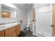 Bright bathroom with a modern vanity, large mirror, and glass-enclosed shower at 1401 Wewatta St # 311, Denver, CO 80202