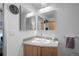 Clean bathroom featuring a vanity with ample storage and large mirrors at 1401 Wewatta St # 311, Denver, CO 80202
