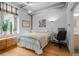 Bedroom filled with natural light, hardwood floors, and a cozy desk area at 1401 Wewatta St # 311, Denver, CO 80202