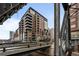 Contemporary brick condo building showcasing balconies, urban setting, and architectural details at 1401 Wewatta St # 311, Denver, CO 80202