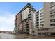 Contemporary multi-story condo building with balconies, street access, and adjacent building at 1401 Wewatta St # 311, Denver, CO 80202