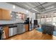 Open-concept kitchen featuring stainless steel appliances, concrete ceilings, and modern finishes at 1401 Wewatta St # 311, Denver, CO 80202