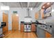 Compact kitchen featuring stainless steel appliances and a breakfast bar at 1401 Wewatta St # 311, Denver, CO 80202
