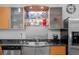 Close-up of kitchen area featuring stainless steel appliances, granite countertops, and modern accents at 1401 Wewatta St # 311, Denver, CO 80202