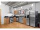 Well-lit kitchen with stainless steel appliances, modern cabinetry, and concrete ceilings at 1401 Wewatta St # 311, Denver, CO 80202