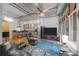 Open-concept living room with exposed ductwork, hardwood floors, modern kitchen, and expansive windows at 1401 Wewatta St # 311, Denver, CO 80202