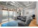 Inviting living room with balcony access, and comfortable seating adjacent to a bedroom area at 1401 Wewatta St # 311, Denver, CO 80202