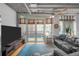 Bright living room features a large window, sliding glass door leading to a balcony, and comfortable seating at 1401 Wewatta St # 311, Denver, CO 80202