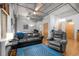 Bright living room featuring hardwood floors, ceiling fan, leather furniture, and large blue rug at 1401 Wewatta St # 311, Denver, CO 80202