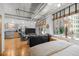 Open living area featuring exposed duct work, kitchen, bedroom, and natural light at 1401 Wewatta St # 311, Denver, CO 80202