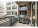 Outdoor patio with BBQ and views of surrounding buildings at 1401 Wewatta St # 311, Denver, CO 80202