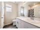 Bright bathroom featuring a window, quartz countertops, modern fixtures, and white cabinetry at 9227 Salida St, Commerce City, CO 80022