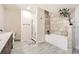 Modern bathroom with a stylish tiled shower, soaking tub, and double vanity at 9227 Salida St, Commerce City, CO 80022