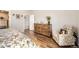 Well-lit bedroom with wood floors, a large dresser, and a comfortable chair, creating a cozy and inviting space at 9227 Salida St, Commerce City, CO 80022