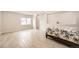 Bright bedroom featuring neutral color palette, tile floors, and a large window at 9227 Salida St, Commerce City, CO 80022