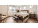 Comfortable bedroom featuring a decorative accent rug, large window, wooden bed frame and comfortable furniture at 9227 Salida St, Commerce City, CO 80022