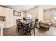 Cozy dining area with a wooden table and chairs, seamlessly connected to the kitchen and living room at 9227 Salida St, Commerce City, CO 80022