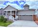 Charming gray two-story home with a covered front porch and two car garage at 9227 Salida St, Commerce City, CO 80022