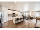 Open-concept kitchen with a large island, stainless steel appliances and a seamless flow into the dining and living areas at 9227 Salida St, Commerce City, CO 80022
