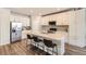 Stylish kitchen featuring white cabinetry, a center island with bar seating, and modern appliances at 9227 Salida St, Commerce City, CO 80022