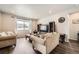 Comfortable living room features plush seating, a large window, and an entertainment center at 9227 Salida St, Commerce City, CO 80022