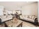 Bright living room featuring modern recessed lighting, wood floors and open access to the kitchen and dining area at 9227 Salida St, Commerce City, CO 80022
