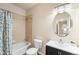 Well-lit bathroom with vanity, modern fixtures, and bathtub with shower in a neutrally decorated space at 6202 Kilmer Loop # 202, Golden, CO 80403