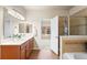 Bathroom features a double sink vanity with wood cabinets and a separate tiled shower at 6202 Kilmer Loop # 202, Golden, CO 80403